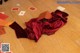 A red bag sitting on top of a wooden floor.