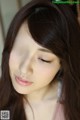 A close up of a woman with long brown hair.