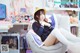 A woman sitting on a chair in front of a computer.